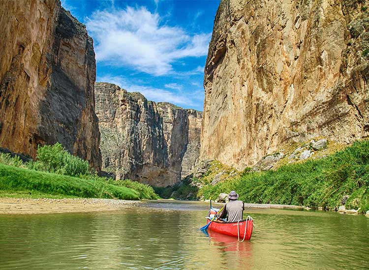 Big Bend River Texas Man in Red Canoe On Water