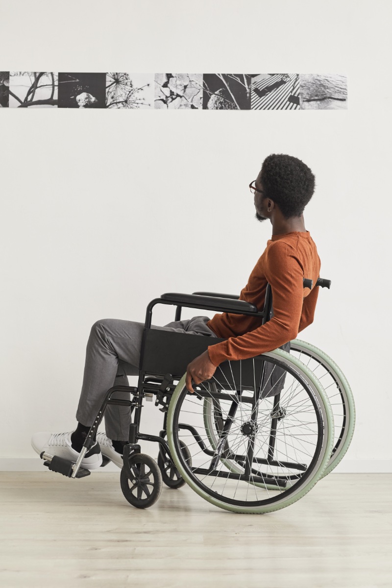 man in wheelchair looking at art