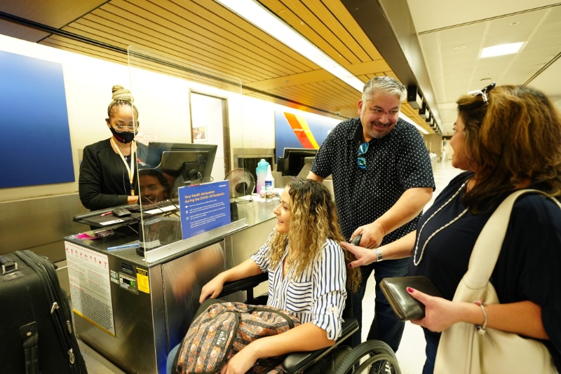 family with their daughter in a wheelchair receiving assistance at LAX