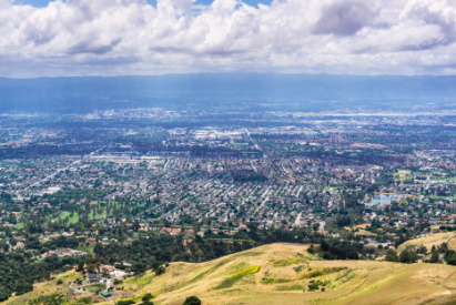 San Jose on a sunny day with rolling green hills and clouds in the sky