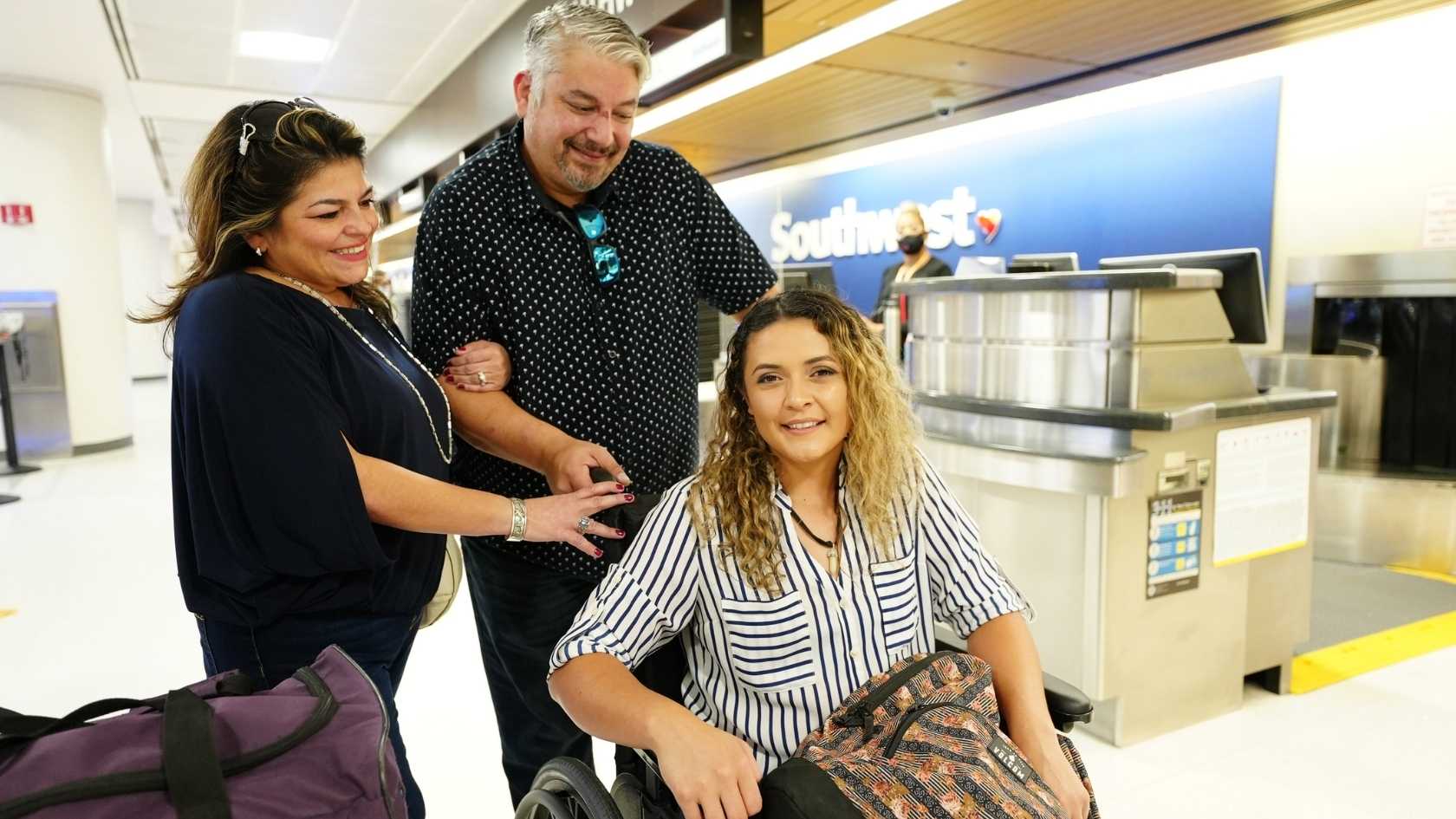 wheelchair traveler at airport check-in with family support accessible travel