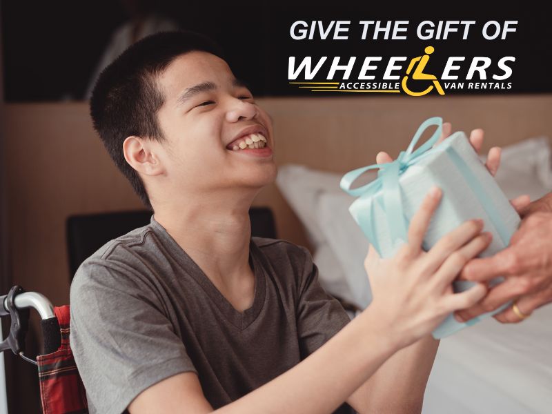 Man in wheelchair receiving a wrapped gift