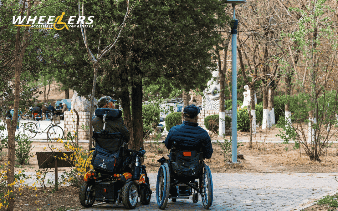 Two wheelchair users in a park