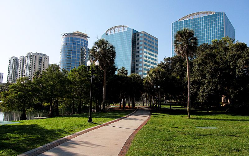 Orlando Municipal Park With Green Grass and Skycrapers in the Background
