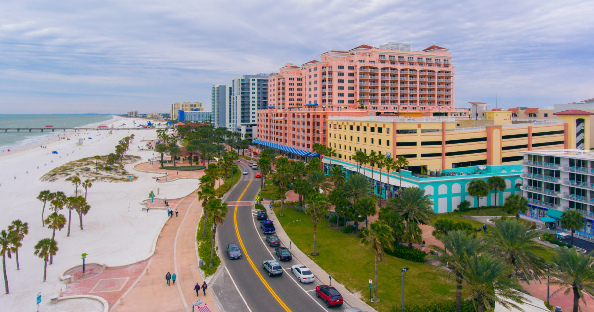 Clearwater Beach white sands and colorful hotels divided by small roadway