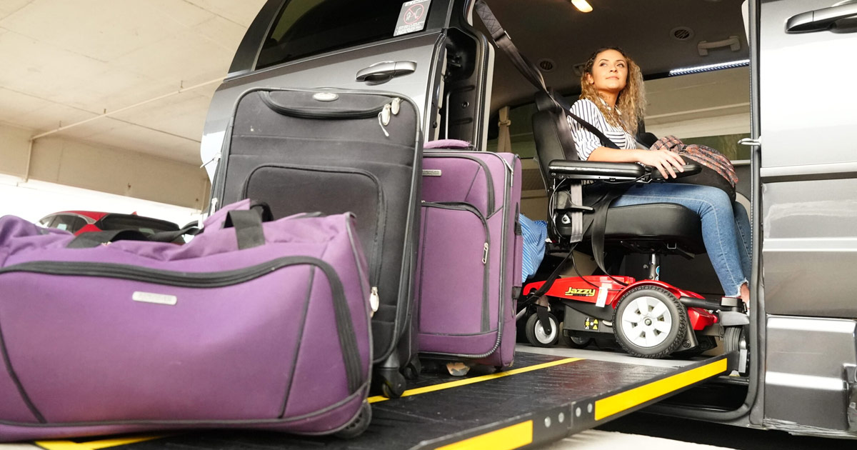 Woman loading her luggage into wheelchair accessible van for vacation
