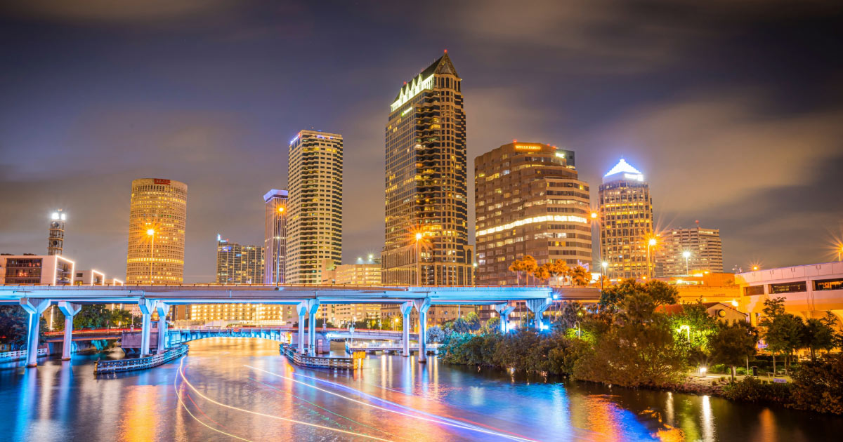 Photo of Tampa skyscrapers and waterway lit up at night