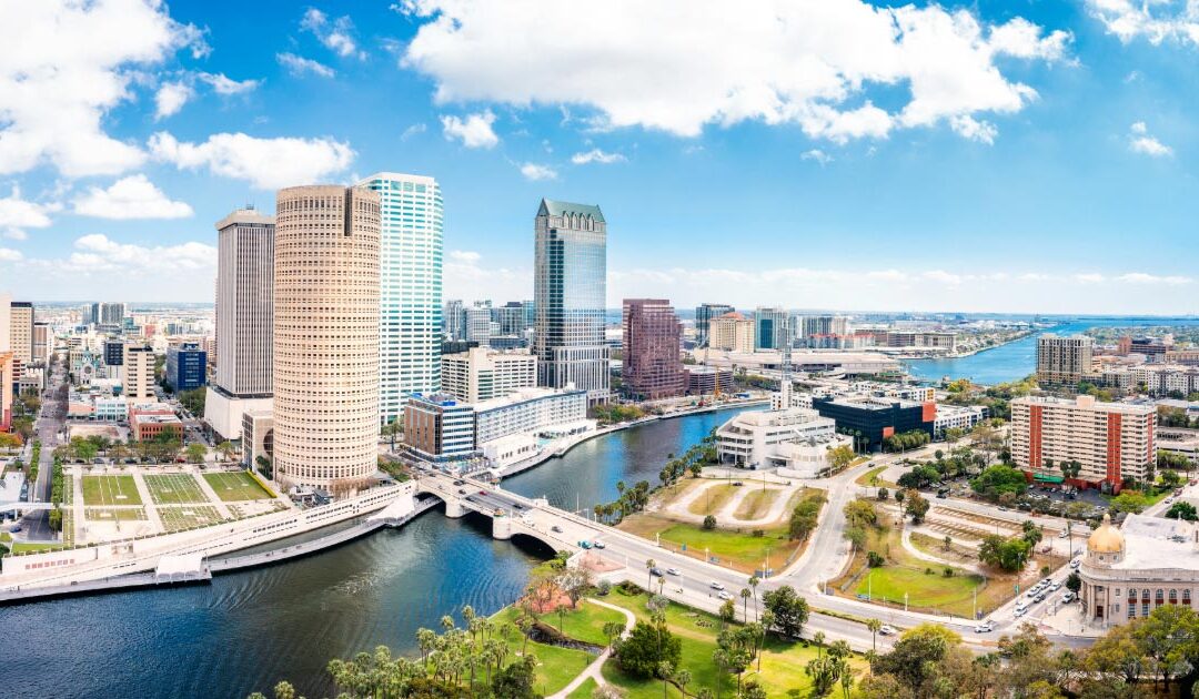 Photo take of Tampa Florida during the day showing tall buildings and waterway park