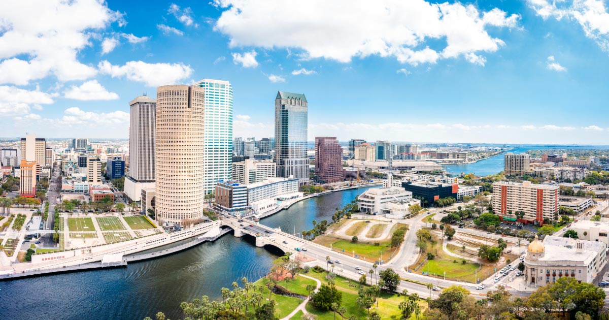 Photo take of Tampa Florida during the day showing tall buildings and waterway park